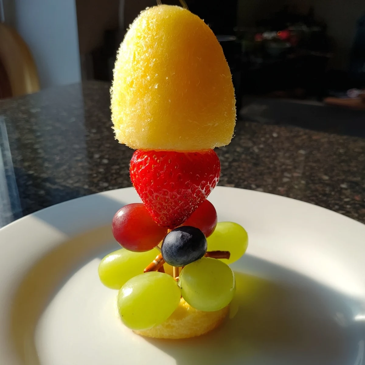 These delicious Christmas Light Fruit Skewers showcase ruby red strawberries, grapes, and pineapple ready to eat.