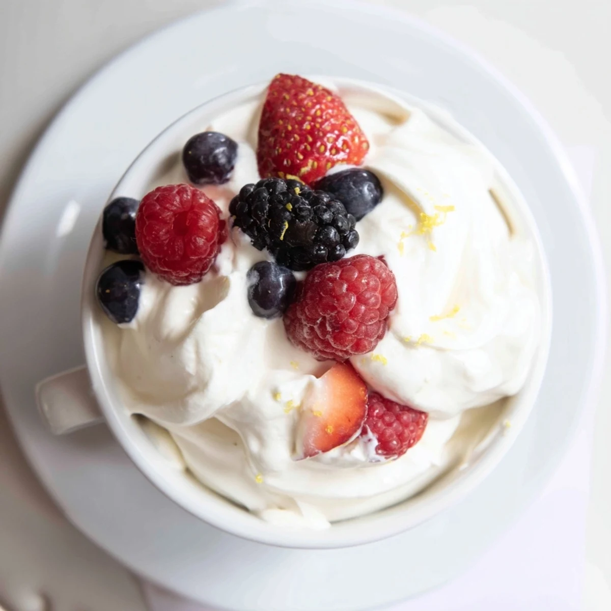 Creamy fluffy fruit dip with cream cheese, beautifully served with a medley of fresh berries.