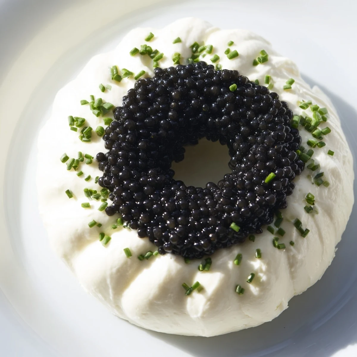 Freshly plated Diamond Inlay appetizer featuring creamy white cheese and dark, luxurious caviar at the center.