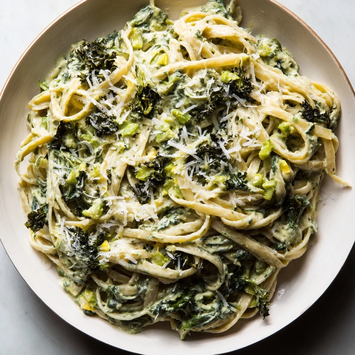 Vibrant Green Goddess Pasta Sauce coats linguine, a flavorful vegetarian main course.