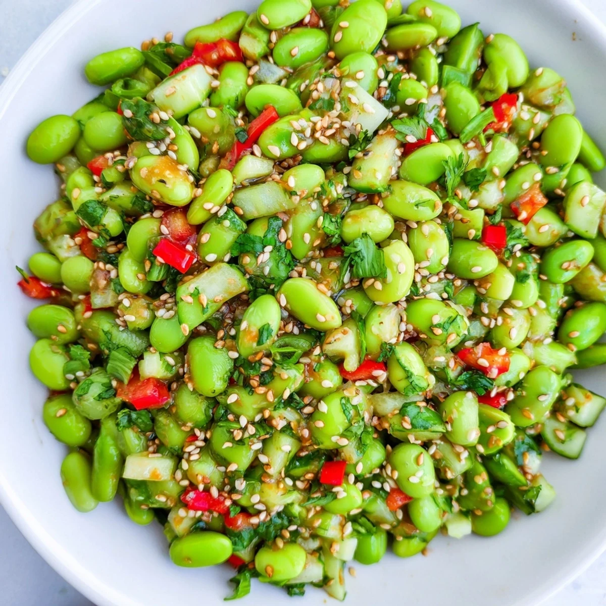 Vibrant edamame salad with crisp cucumber and a creamy sesame dressing, a delicious side.