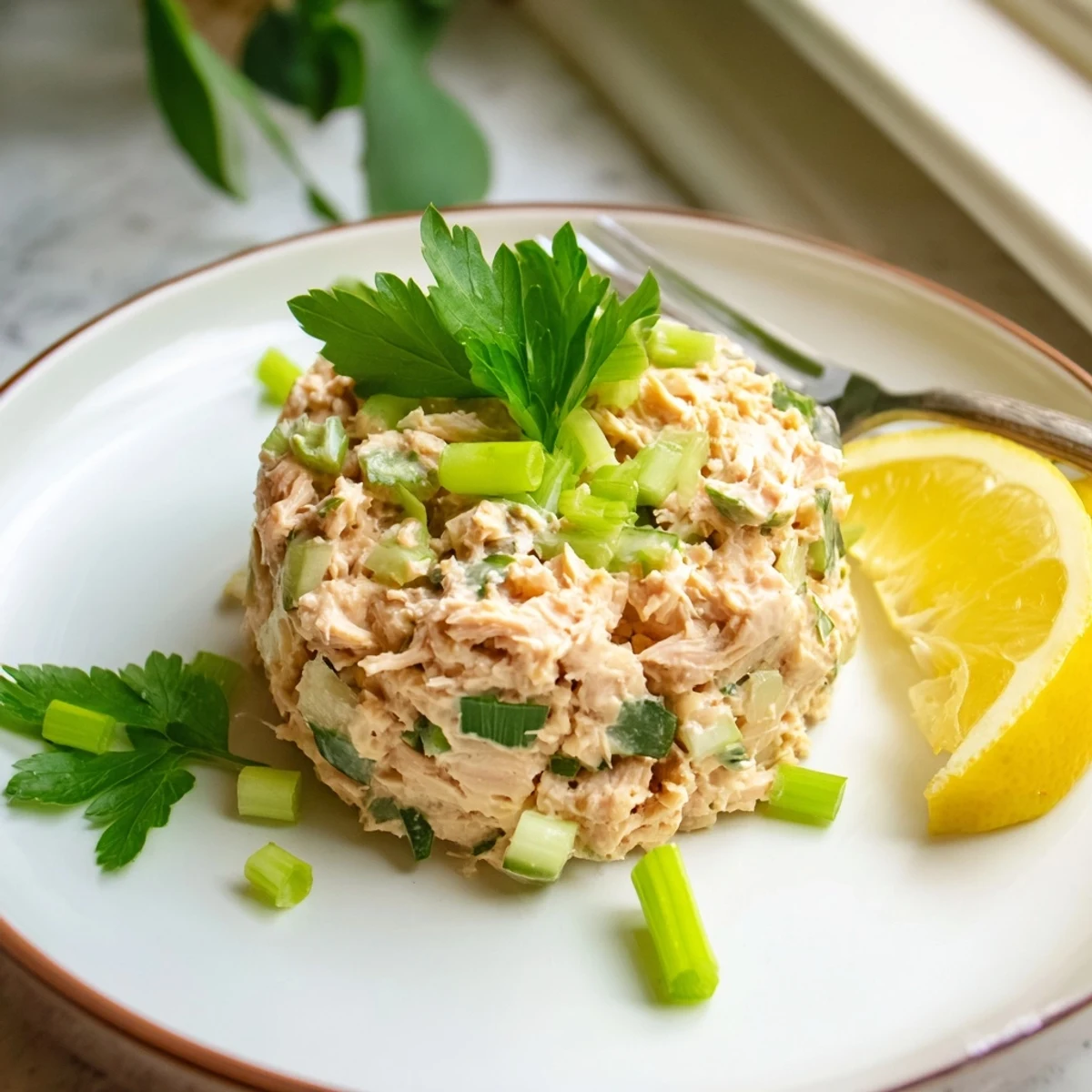 Spicy Zesty Tuna Salad served in crisp lettuce wraps, topped with sliced scallions and a drizzle of lemon juice.