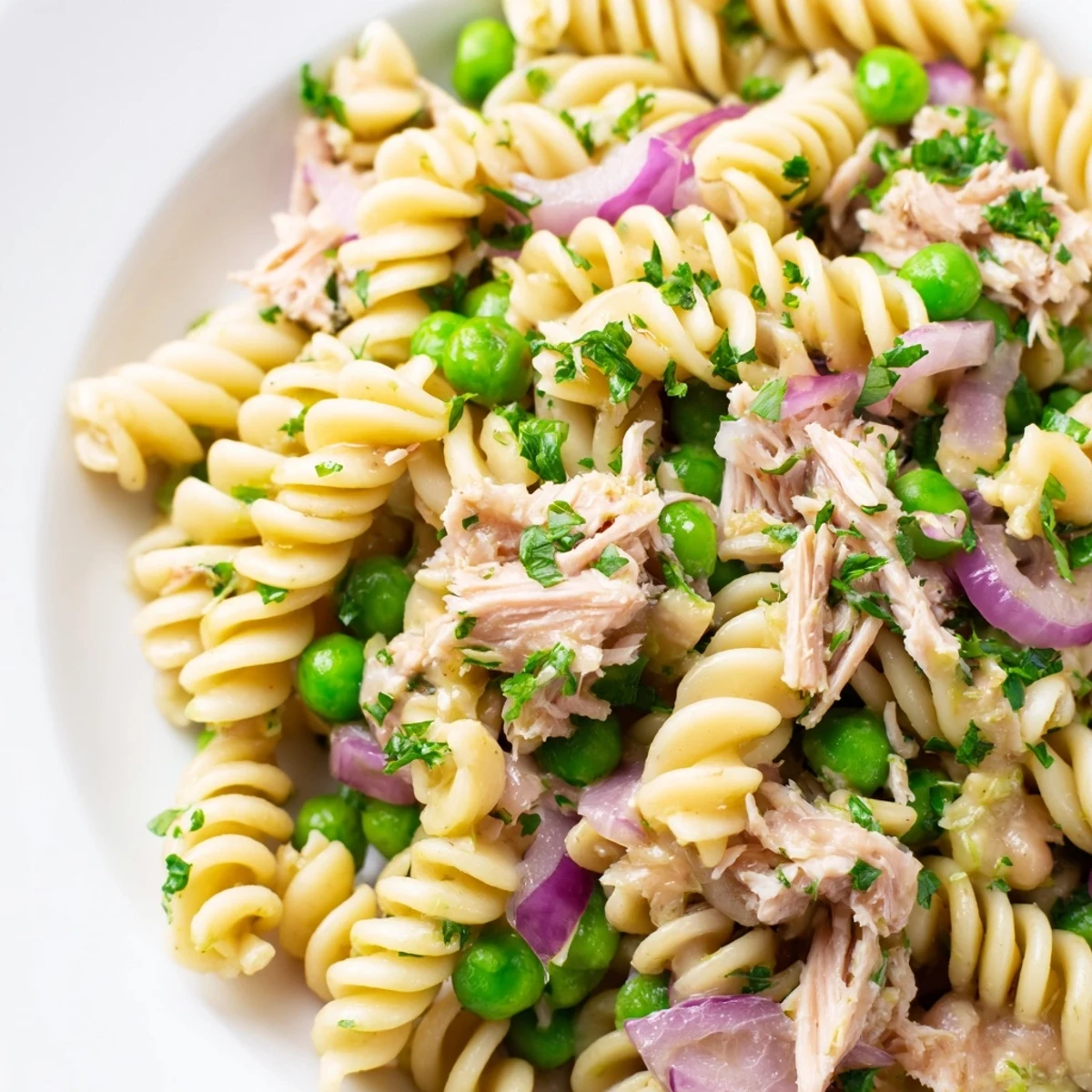 Lemony Tuna Pasta Salad featuring al dente fusilli, lemon zest, and capers, garnished with dill and ready to enjoy chilled.