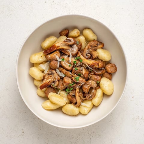 Golden skillet of Woodsy Sausage and Mushroom Gnocchi, a creamy comfort food dinner.