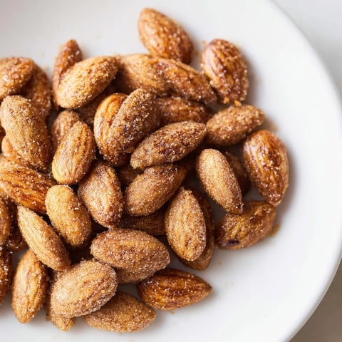 Crispy, sweet cinnamon roasted almonds, golden brown and perfectly spiced for a delicious snack.