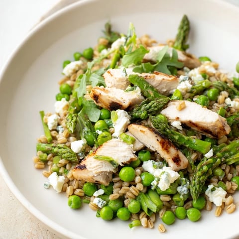 Warm Spring Farro Chicken Salad features tender grains and sliced chicken tossed with crisp asparagus and peas.
