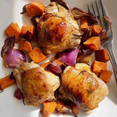 Aromatic Honey-Glazed Chicken sits atop colorful roasted root vegetables; a comforting gluten-free meal.