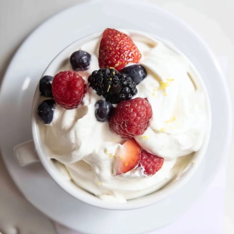 Creamy fluffy fruit dip with cream cheese, beautifully served with a medley of fresh berries.