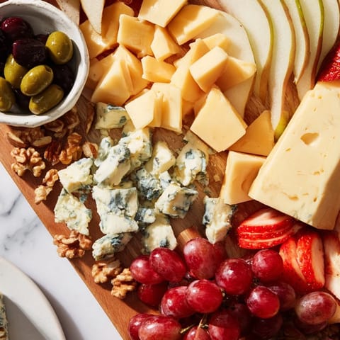 Overflowing Waterfall Edge Grazing Board featuring assorted cheeses, cured meats, and fresh fruits creating visual appeal.