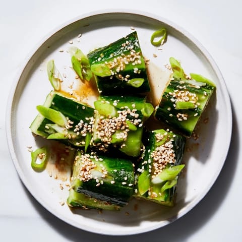 Close-up of a colorful Cucumber Shaker, featuring crunchy cucumbers and an umami dressing.
