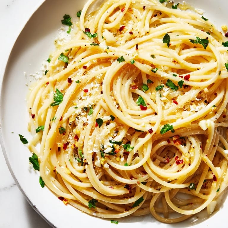 Aglio e Olio Express Pasta, a simple dish of spaghetti glistening in garlicky olive oil and spices.