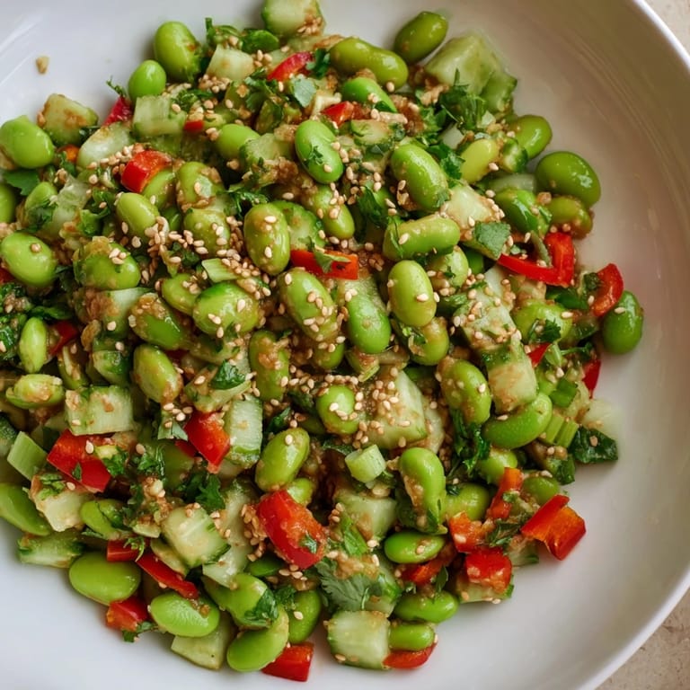 Close-up of refreshing edamame salad featuring green edamame and a sprinkle of toasted sesame seeds.