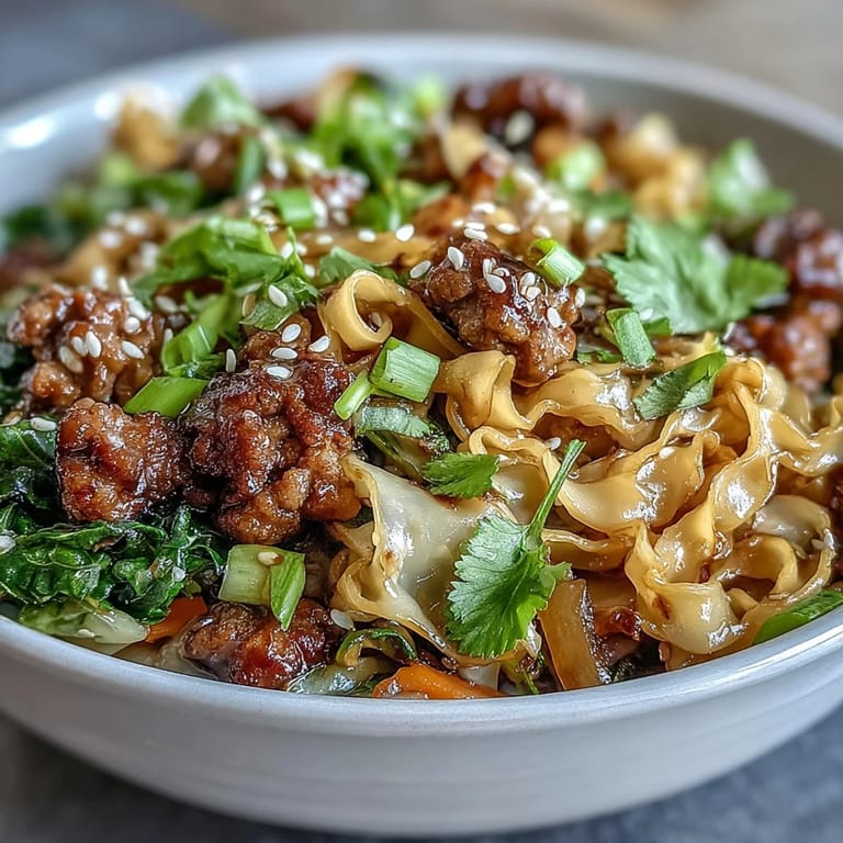 Potsticker Noodle Bowls served in a ceramic dish, garnished with green onions and sesame seeds for a weeknight dinner.