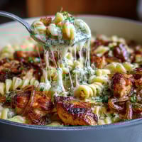One-Pot French Onion Chicken Pasta with caramelized onions and melted Gruyère in a creamy broth.  